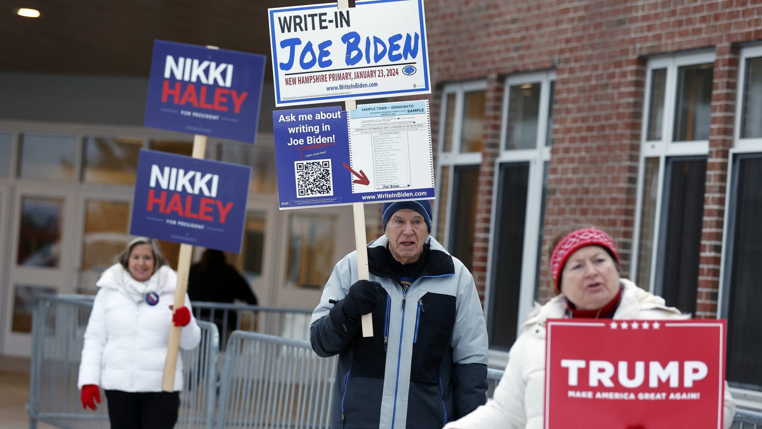 Candidate supporters stand outside a polling location in the presidential primary election, Jan. 23...