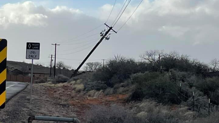 Crews working on a power pole that was damaged when heavy winds blew through the area near Shivwits...