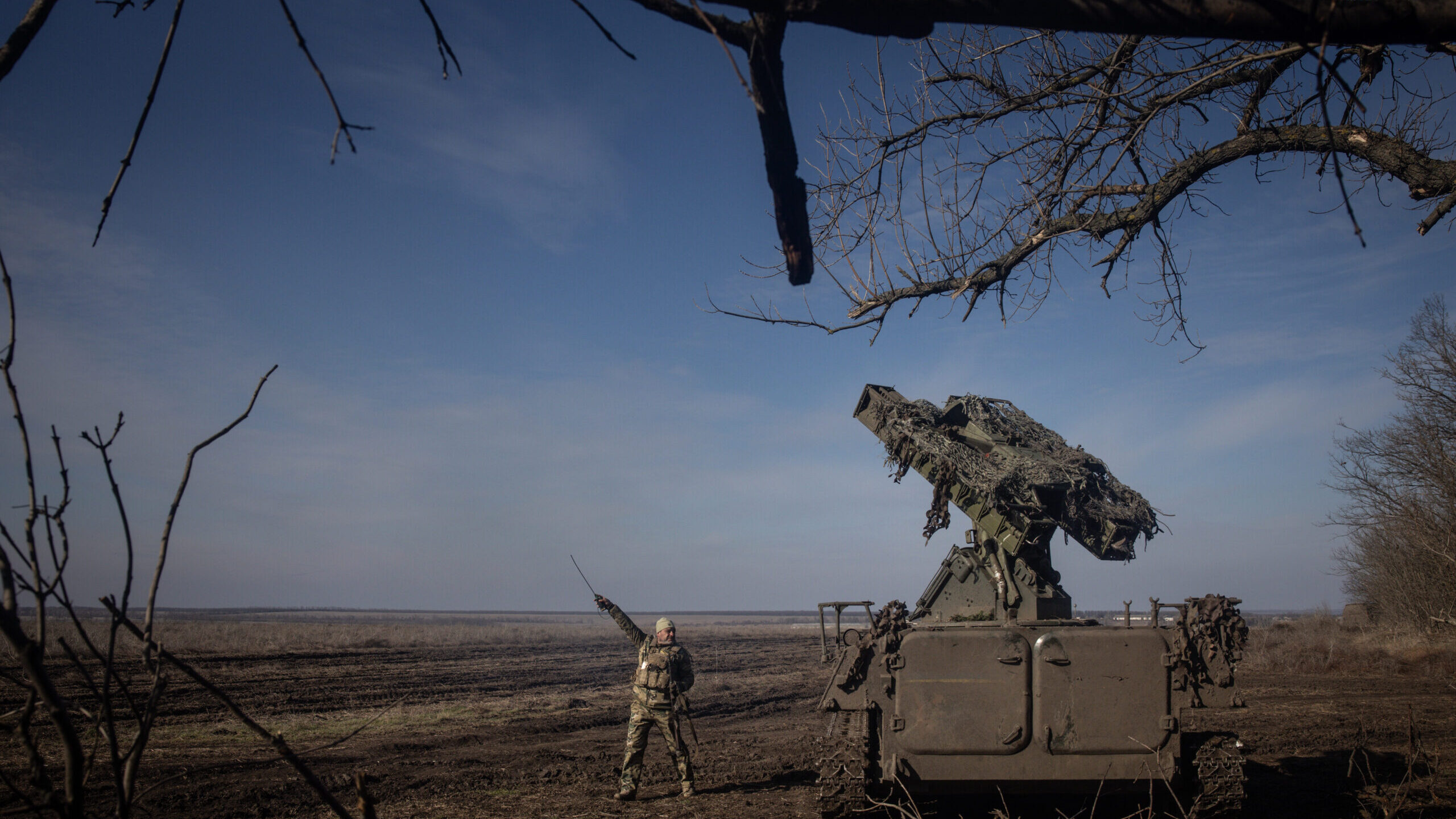 A member of Ukraine's 72nd Brigade Anti-air unit points to the direction of a Russian Zala reconnai...