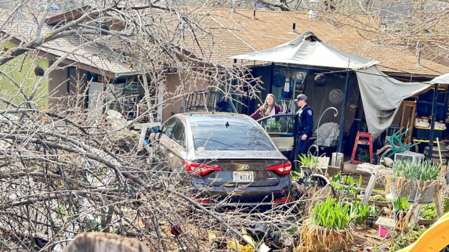 Scene where an out-of-control Hyundai Sonata flew into the backyard of a home, Washington City, Uta...