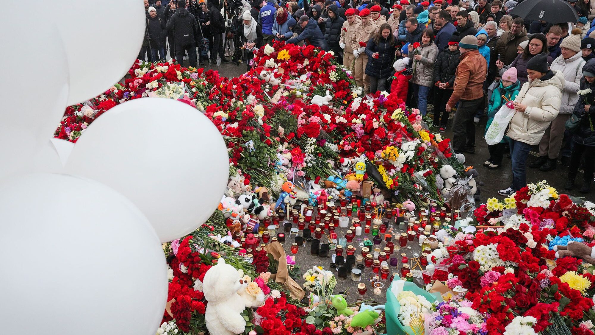 People place flowers at a memorial outside Crocus City Hall in Moscow on Sunday following Friday's ...