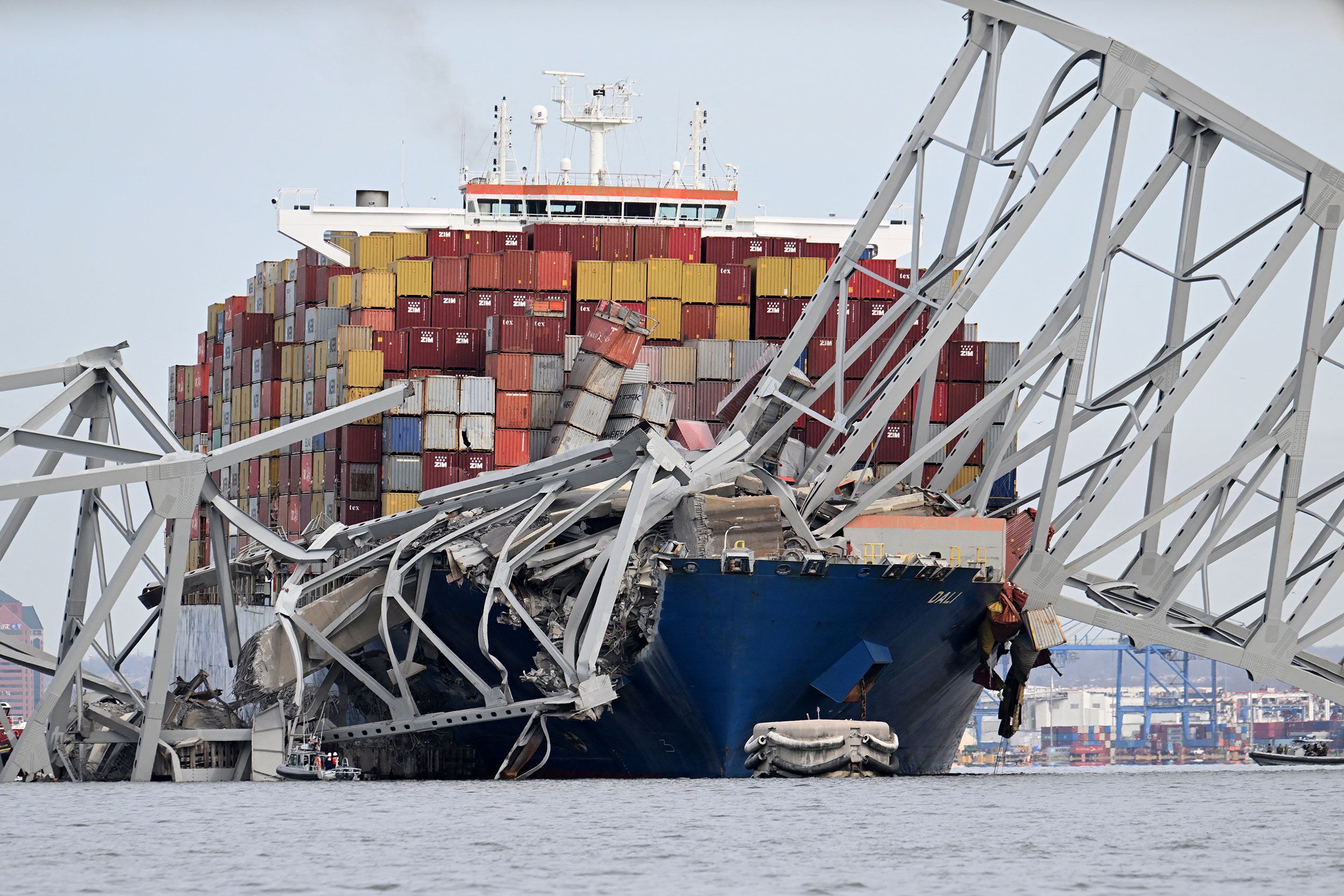 The steel frame of the Francis Scott Key Bridge sits on top of the container ship Dali after the br...