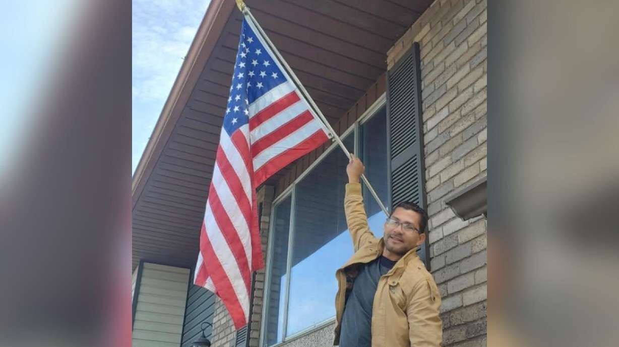 Alberto Marcano, originally from Venezuela and more recently of Provo, is shown with a U.S. flag in...