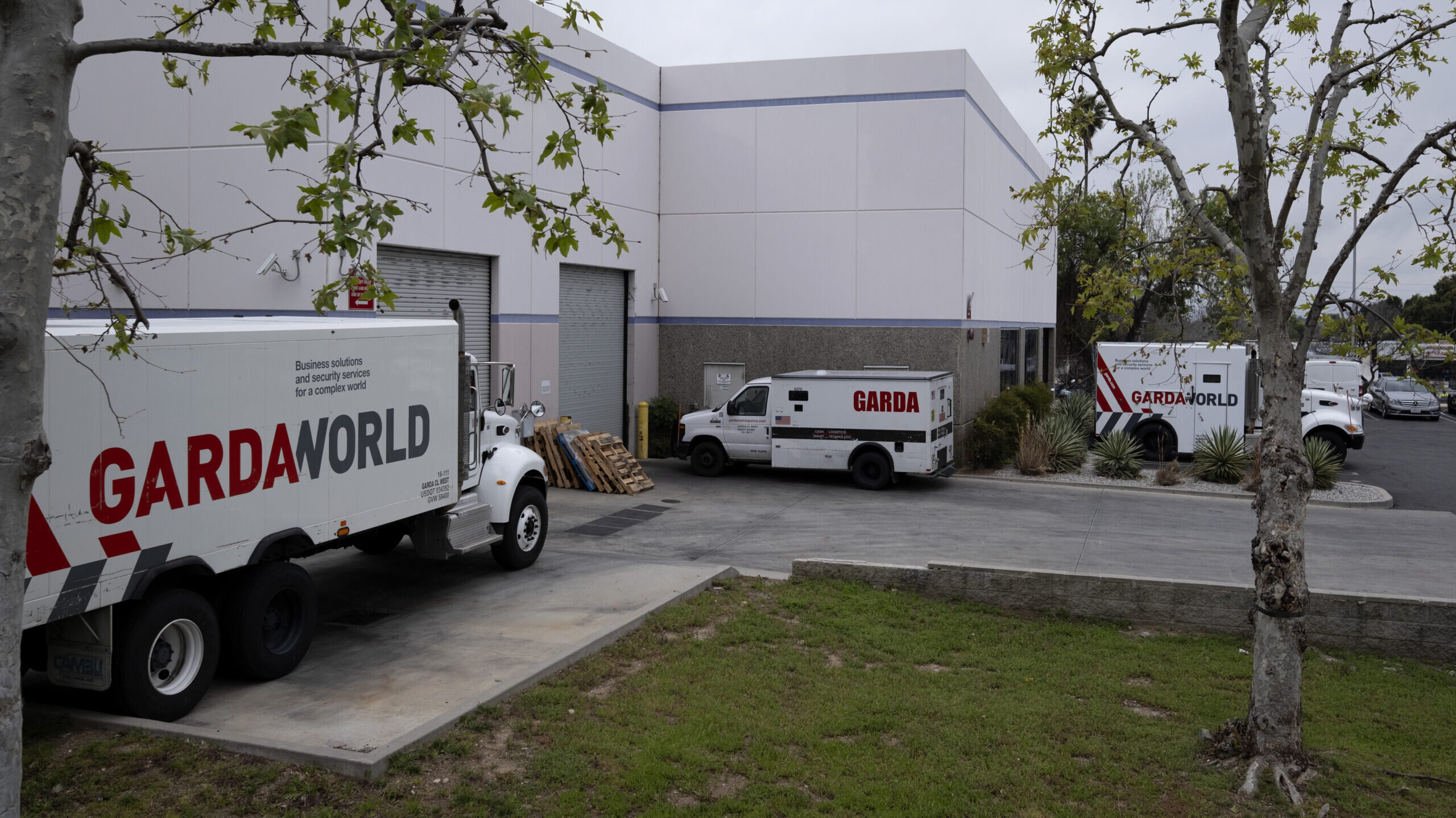 Armored trucks are parked outside the GardaWorld facility in the Sylmar section of Los Angeles on T...