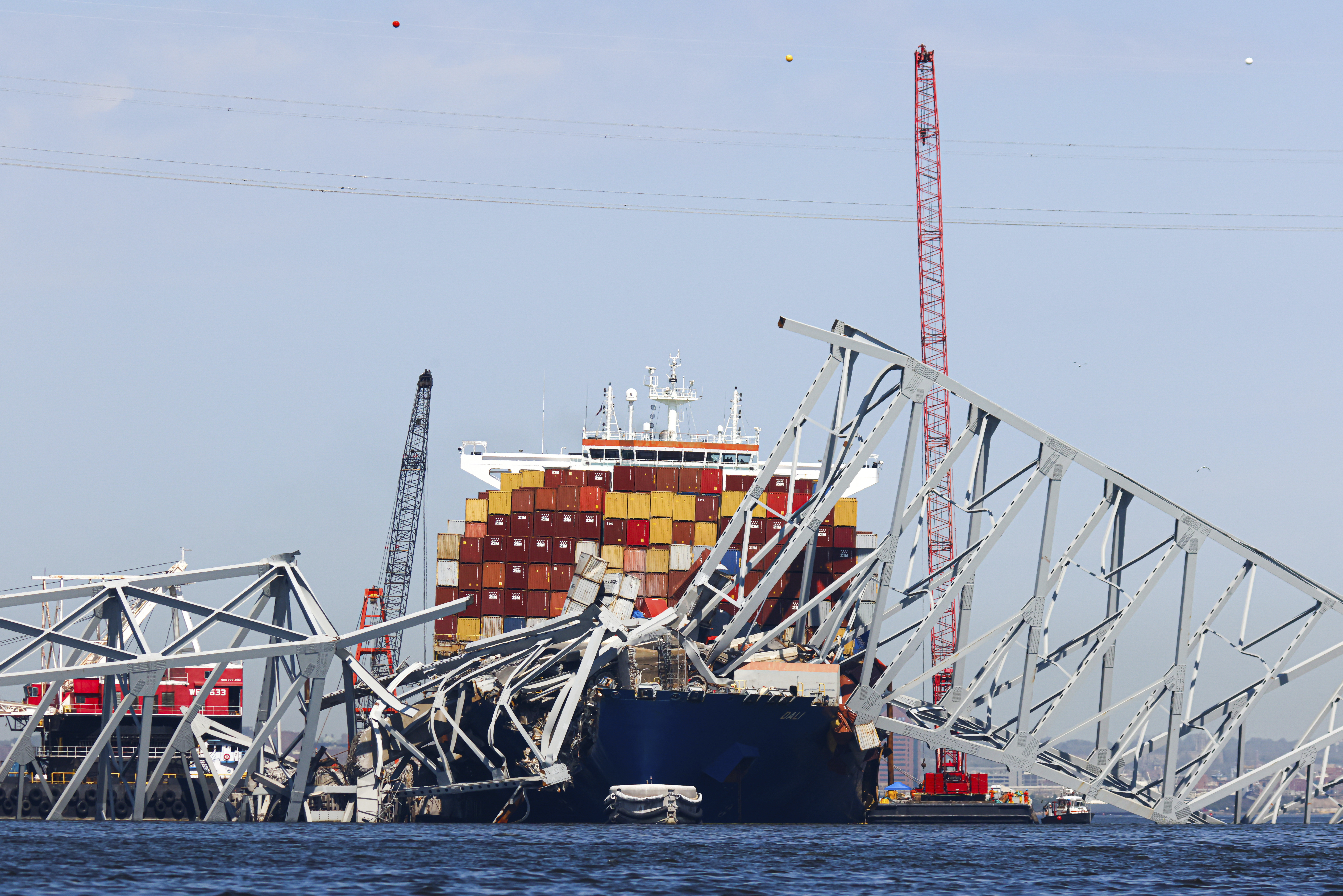 The collapsed Francis Scott Key Bridge lay on top of the container ship Dali, Monday, April 15, 202...