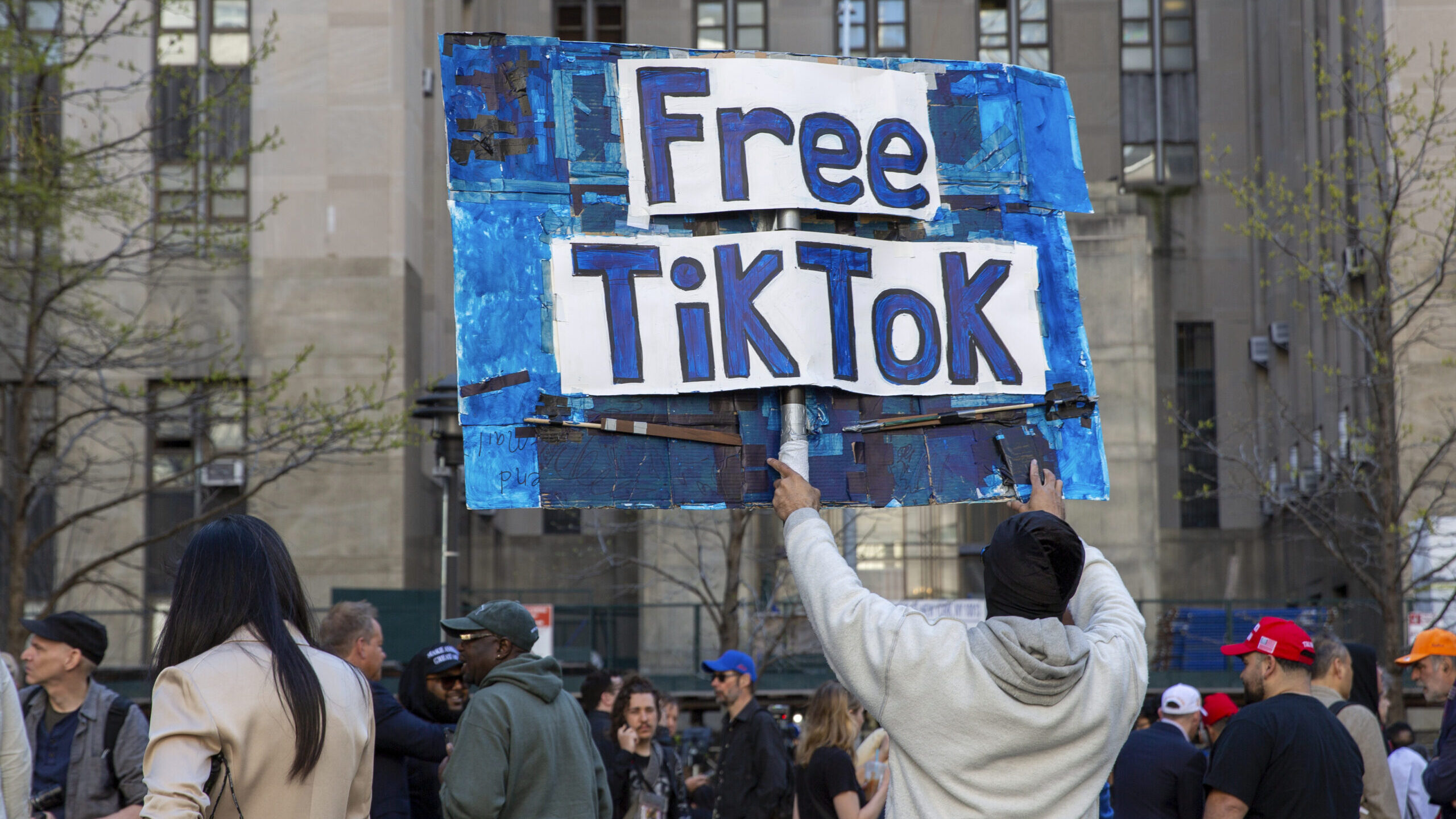 A man carries a Free TikTok sign in front of the courthouse where the hush-money trial of Donald Tr...