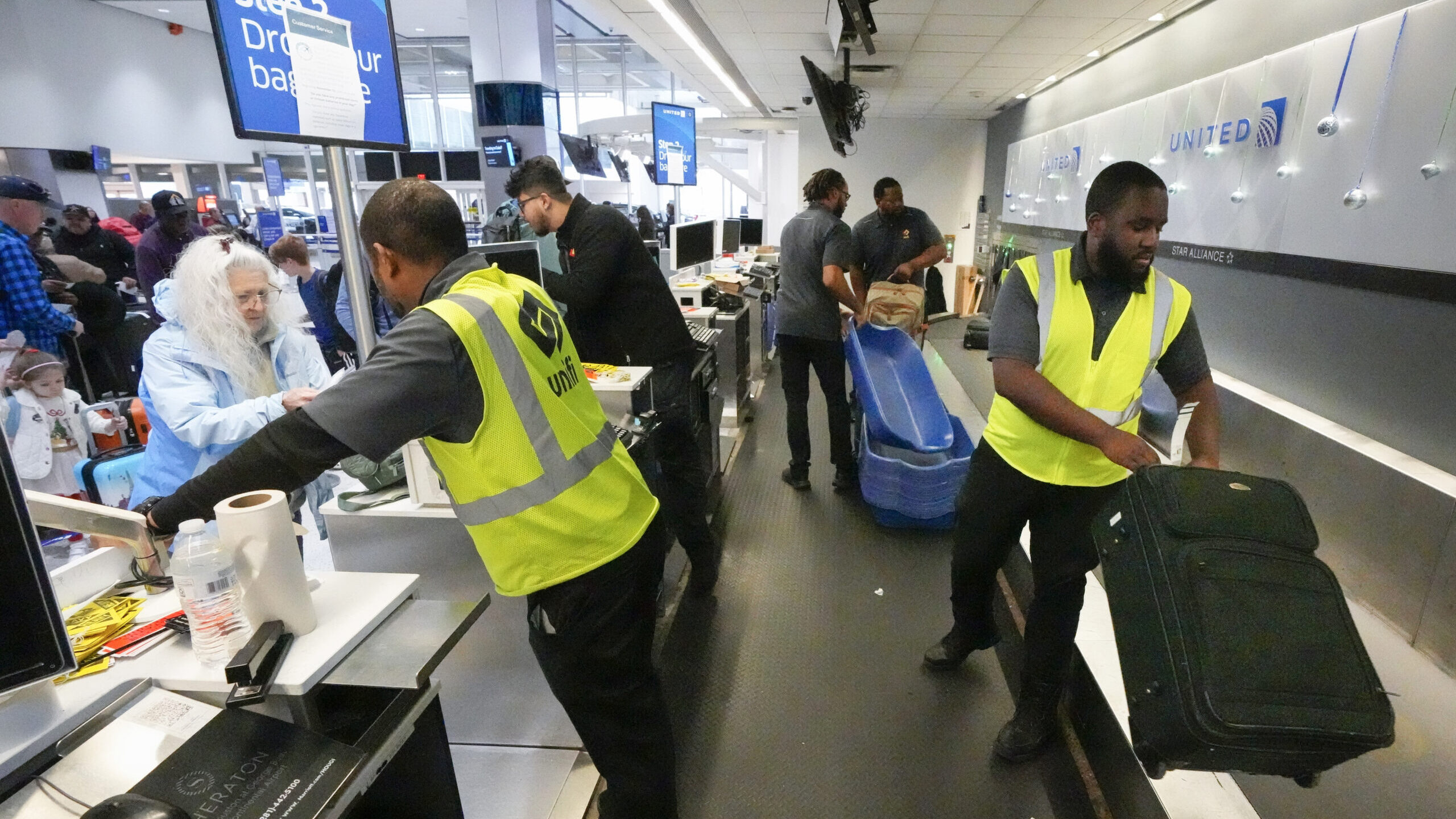 Passenger drop off their baggage at United Airlines in C Terminal at George Bush Intercontinental A...