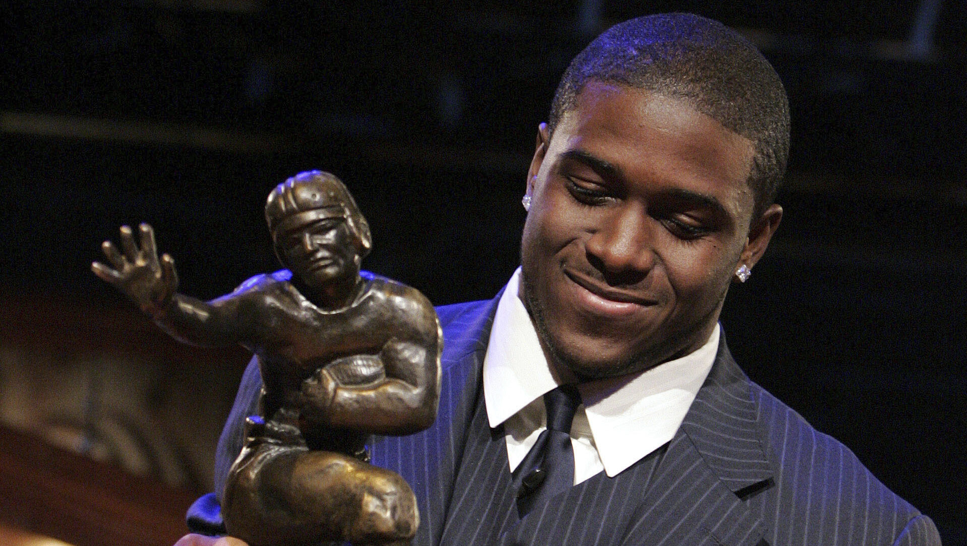 Southern California tailback Reggie Bush picks up the Heisman Trophy after being announced as the w...