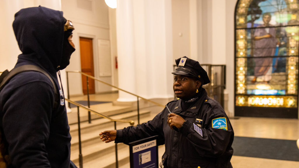a police officer confronts a columbia university protesters...