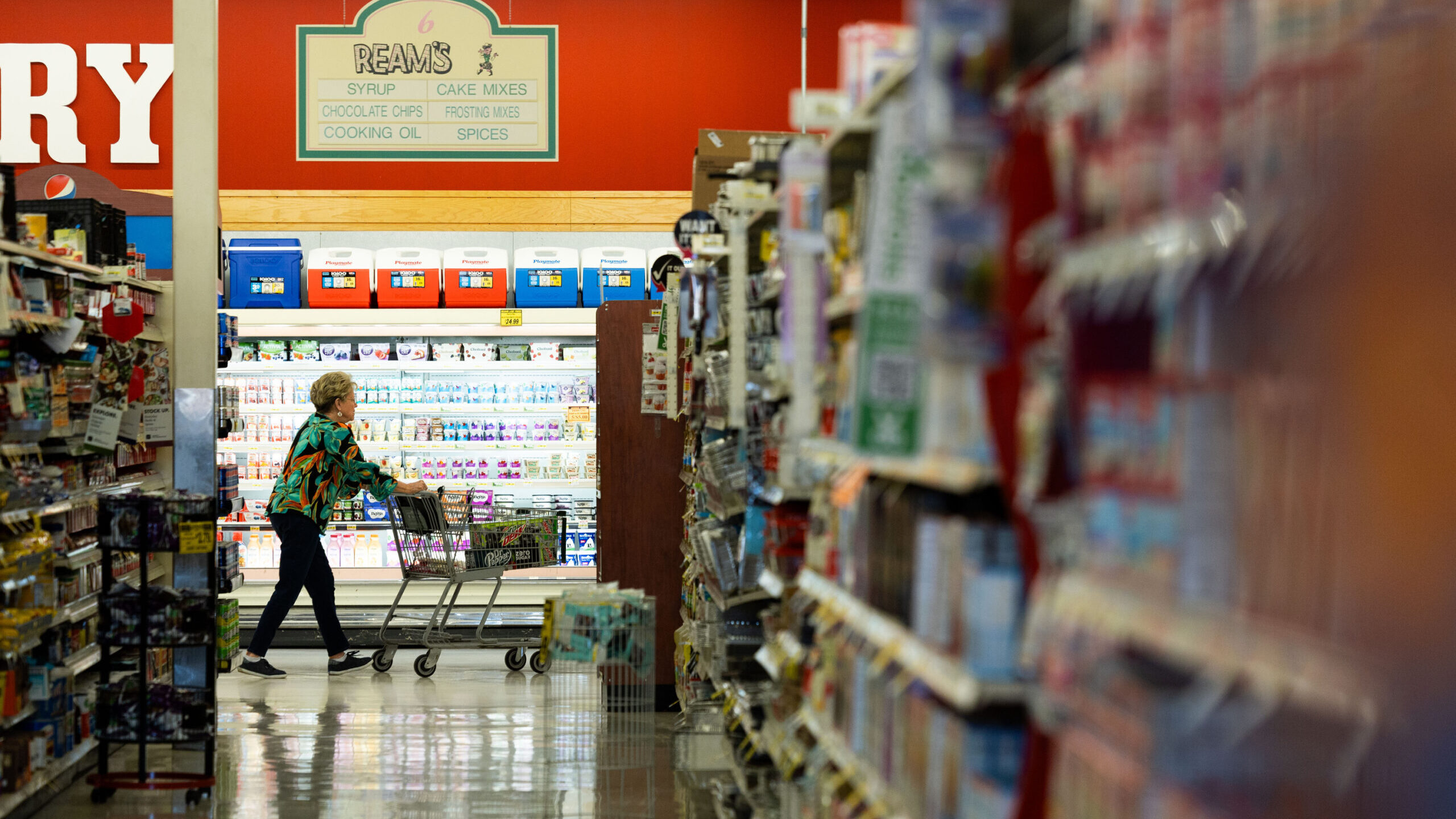 A customer passes by an isle in a grocery store in Utah. Grocery spending has risen significantly s...