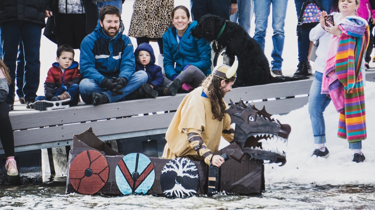 a person dressed up as a nordic viking in a dragon boat resembling the bear lake monster...