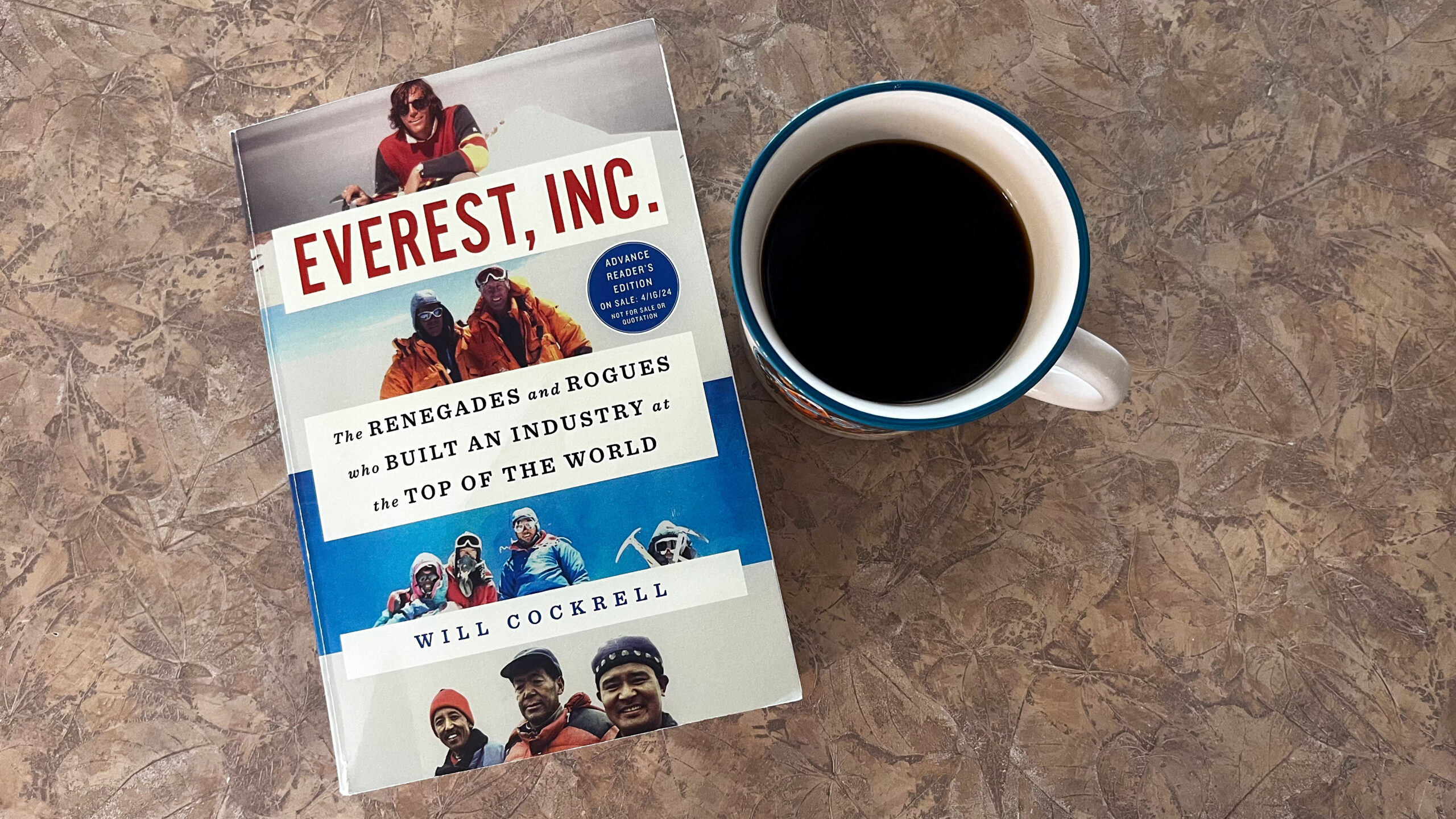 A promotional pre-release copy of Everest, Inc., provided by Gallery Books, sits next to a cup of c...