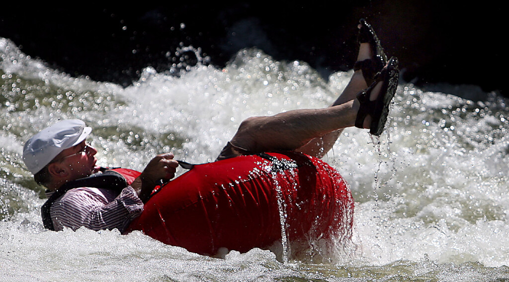 David Gordon of North Ogden starts to flip off his innertube on the Weber River near Henefer on Thu...