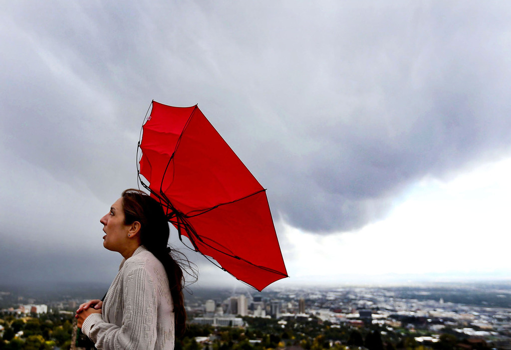 Kara Smith of Brooklyn, New York, almost loses her umbrella as a gust of wind pops it open at Ensig...