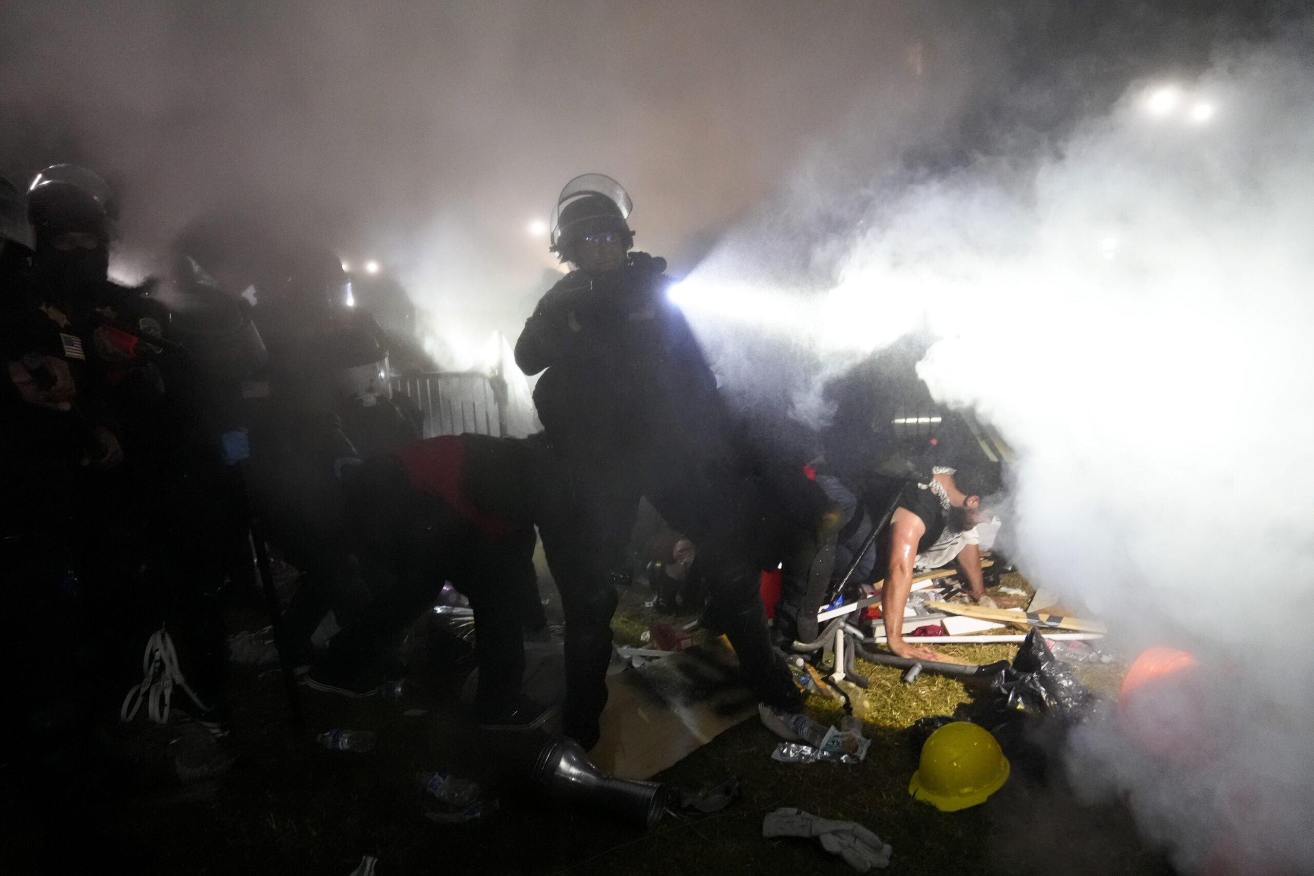 Police enter an encampment set up by pro-Palestinian demonstrators on the UCLA campus Thursday, May...