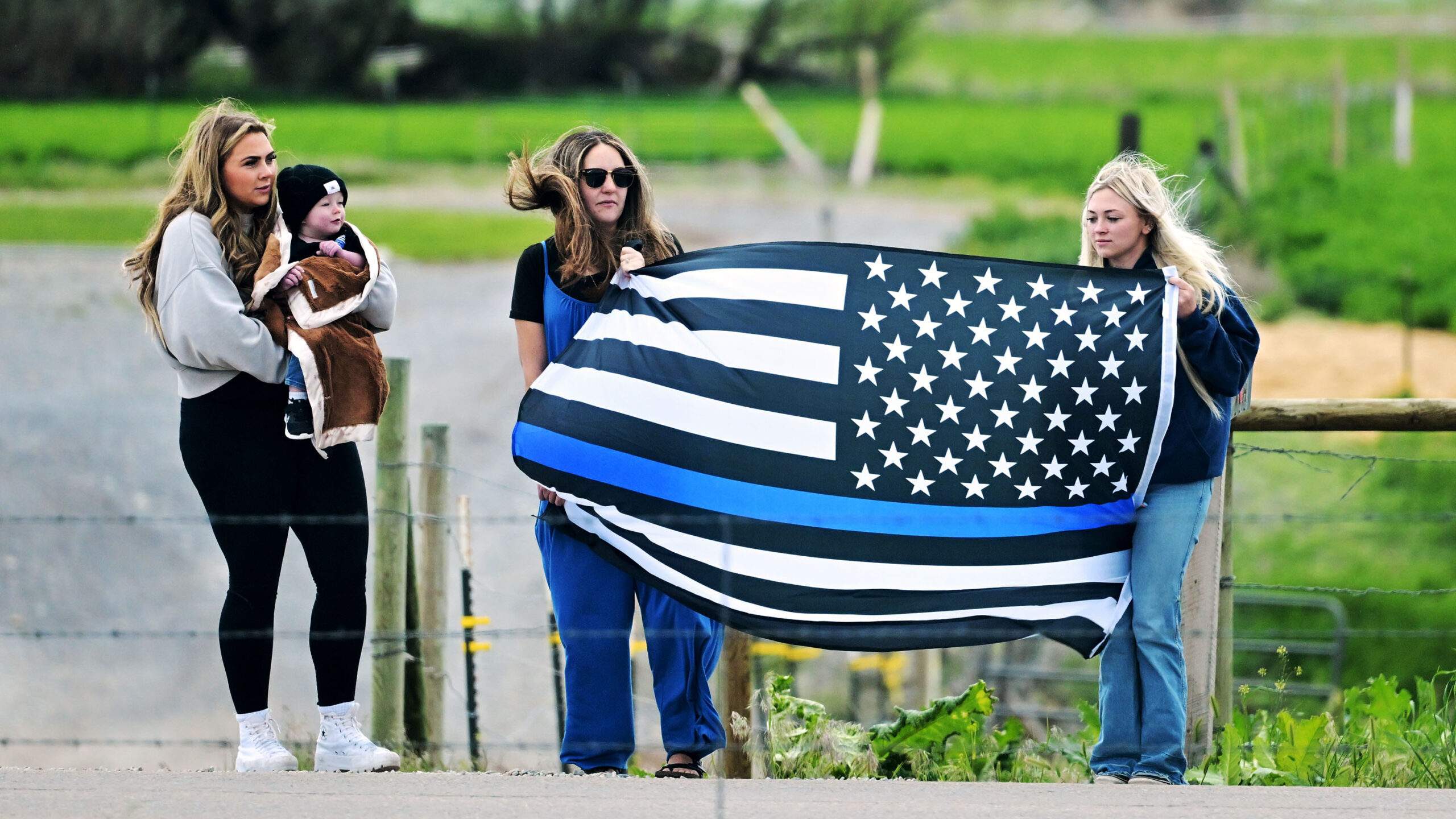 Community members watch as the procession from Taylorsville to bringing fallen Santaquin officer Sg...