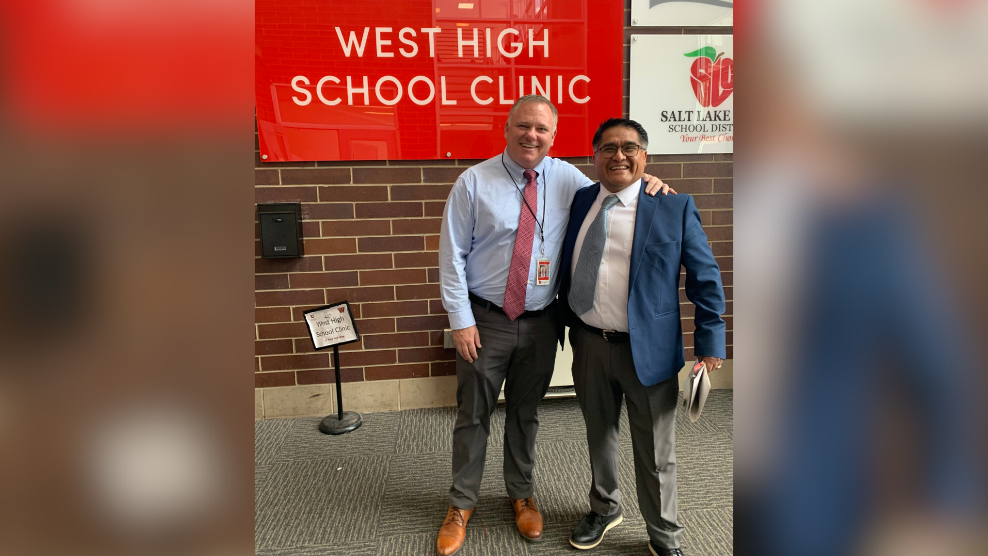 West High Principal Jared Wright with James Yapias in front of west high clinic sign...