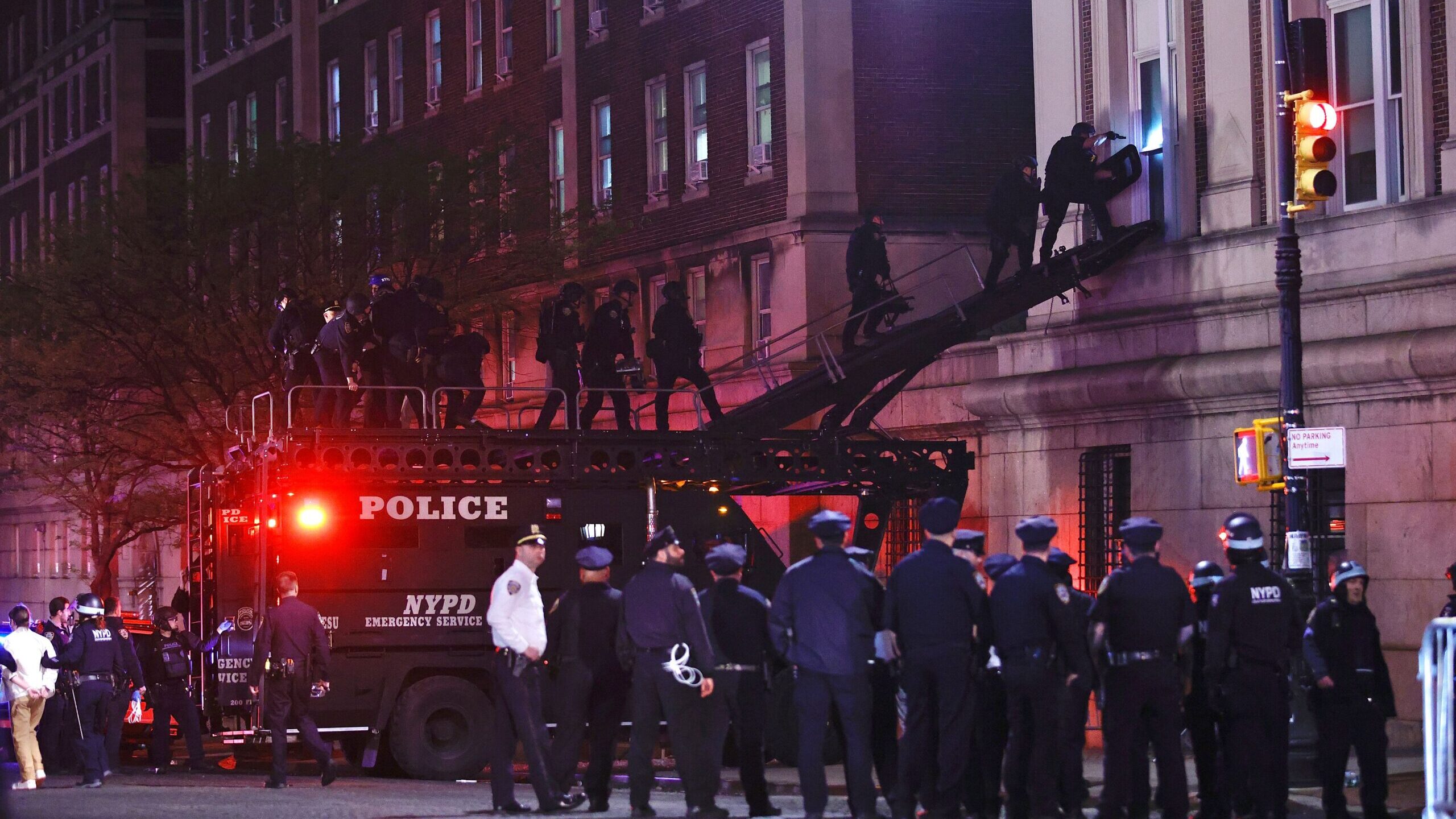 NYPD officers in riot gear break into a building at Columbia University, where pro-Palestinian stud...