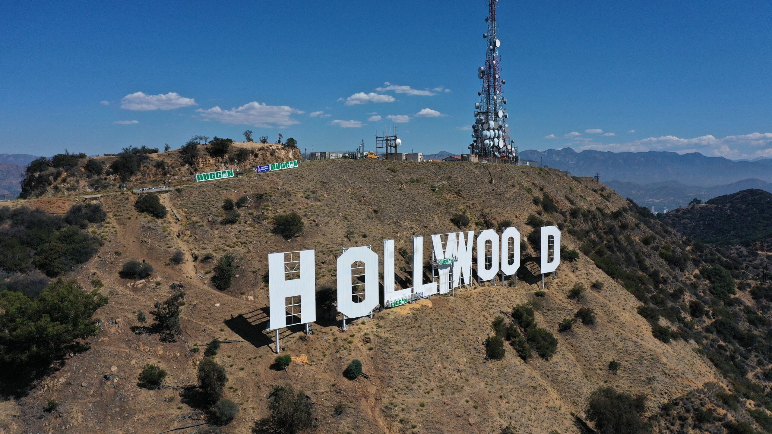 The Hollywood sign during its repainting in 2022. The area in and around Hollywood will start hosti...