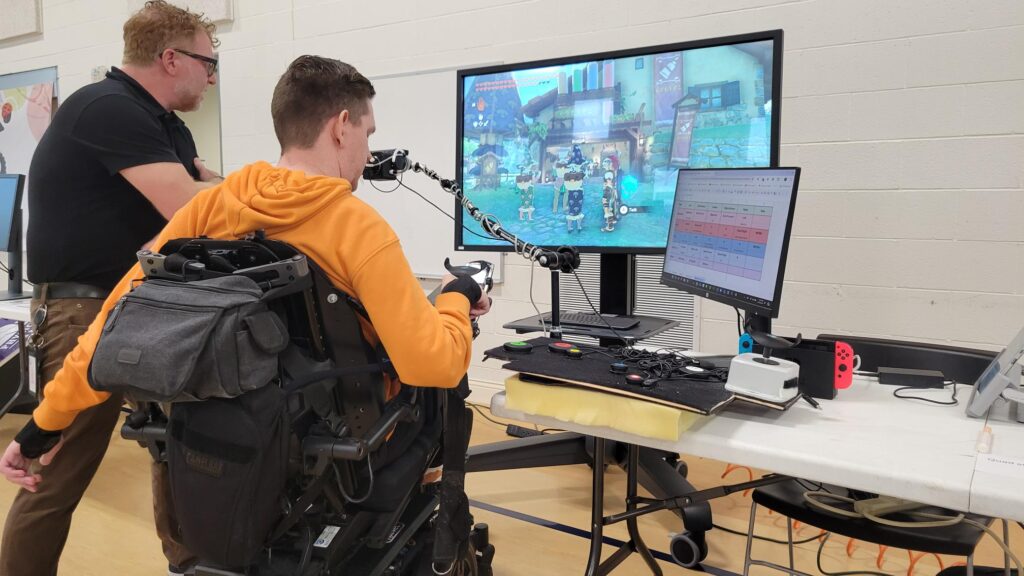 two people look at a computer screen during adaptive recreation fair