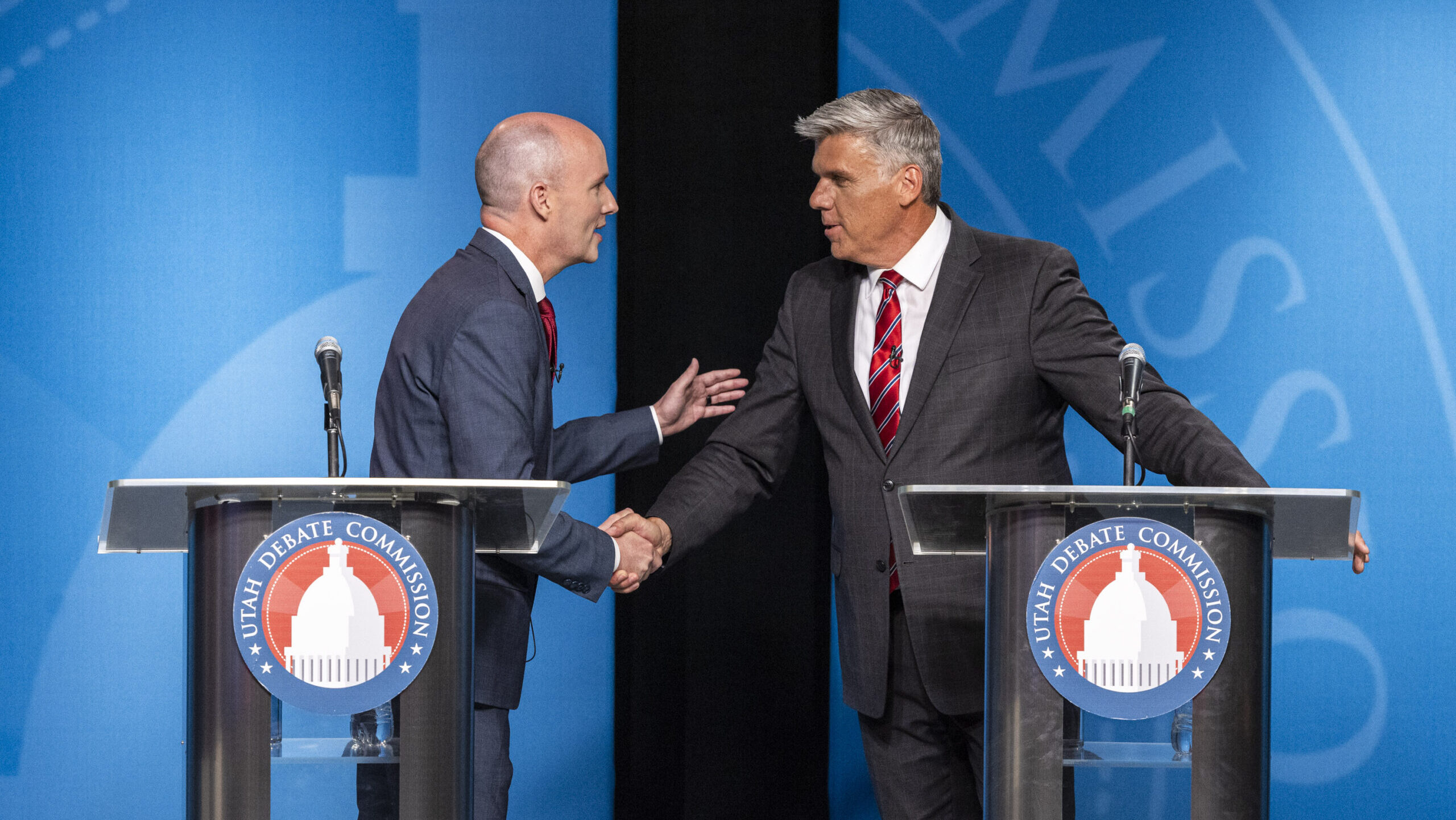 Governor Spencer Cox and Utah Rep. Phil Lyman shake hands at a debate hosted at the Eccles Broadcas...