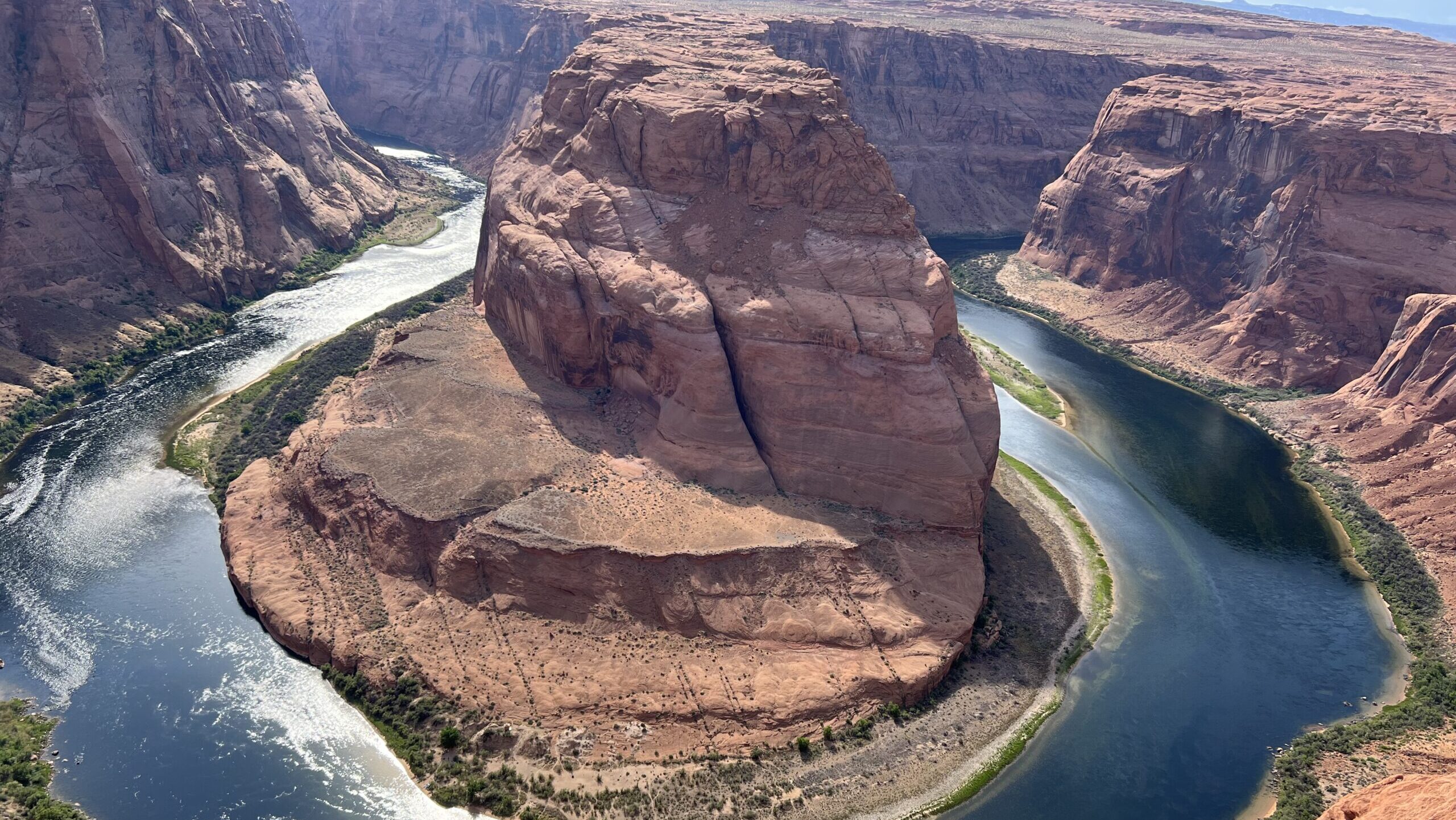 Blue water forms Horseshoe Bend...