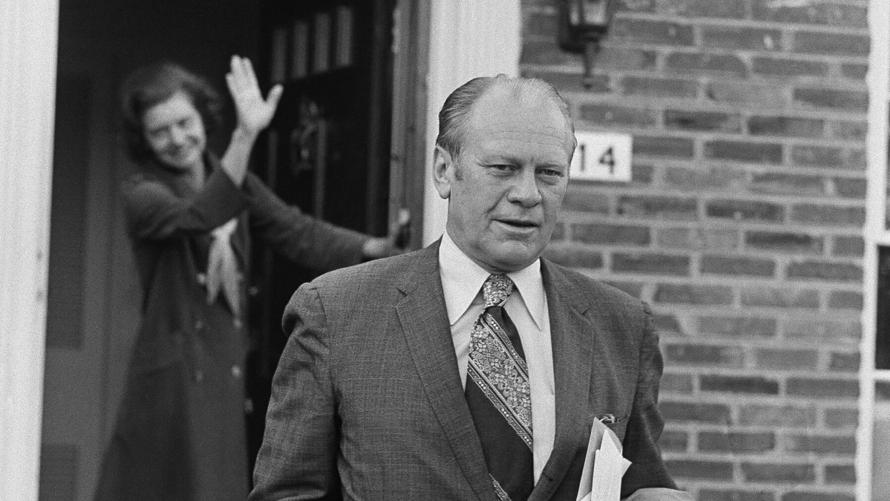 Vice President Gerald Ford gets a wave from his wife Betty early Dec. 7, 1973, as he left their hom...