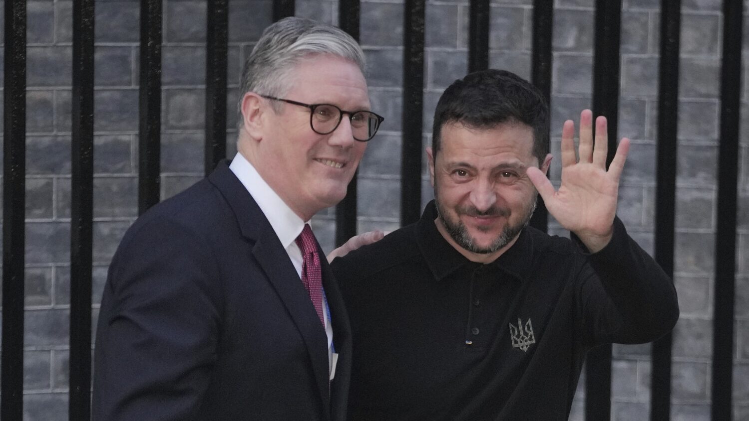 Britain's Prime Minister Keir Starmer, left, greets Ukraine's President Volodymyr Zelenskyy in Down...