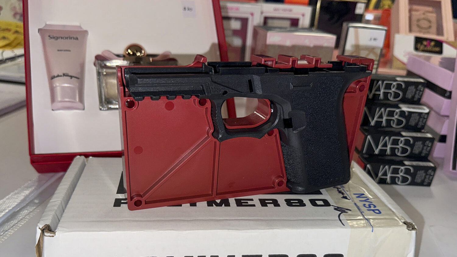 FILE - A ghost gun that police seized from an organized shoplifting crime ring is on display during...
