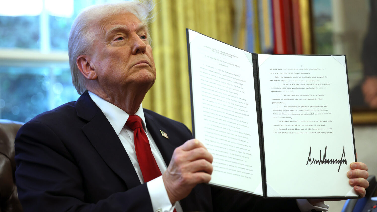 WASHINGTON, DC - MARCH 26: U.S. President Donald Trump displays a signed an executive order in the ...