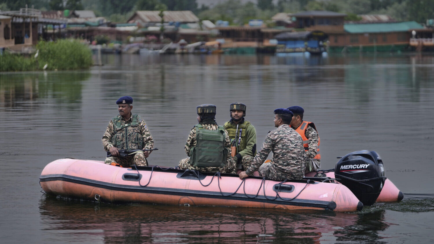 Paramilitary soldiers patrol on an inflatable boat on Dal Lake after loud explosions were heard in ...