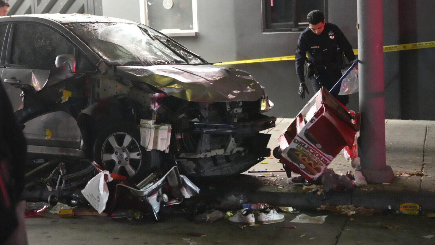 A vehicle sits on the sidewalk after ramming into a crowd of people waiting to enter a nightclub al...