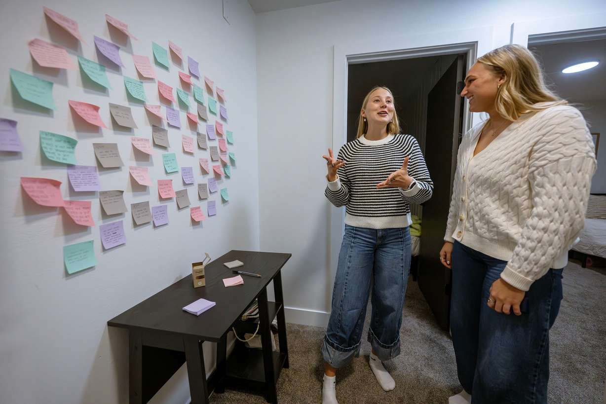 BYU students Katrina Hafen and roommate Alexa Plyer show a wall of Post-it notes they keep with blessings they feel they have received while not using smartphones, during an interview at their apartment on Sunday, Nov. 30, 2025. They and another roommate, Hallie Martinson, made the choice to do away with their smartphones for a time. | Scott G Winterton, Deseret News