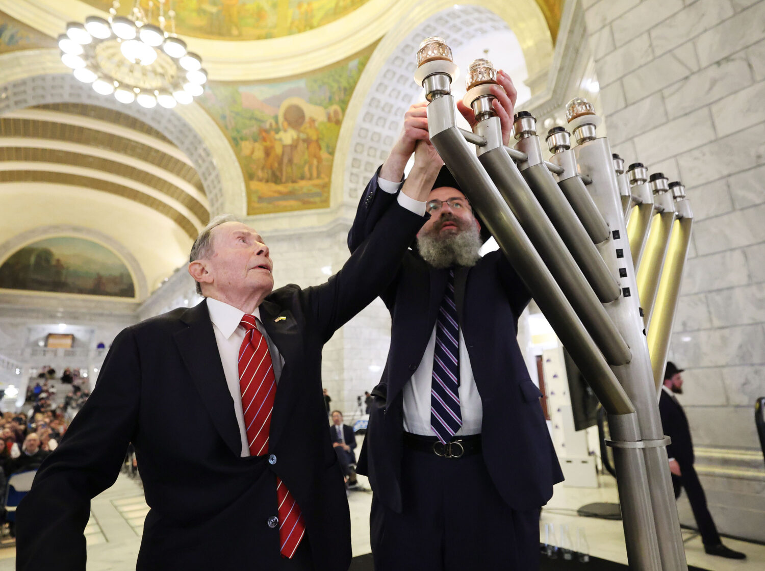 U.S. Ambassador John M. Price and Rabbi Benny Zippel light the menorah during the Utah Chanukah cel...