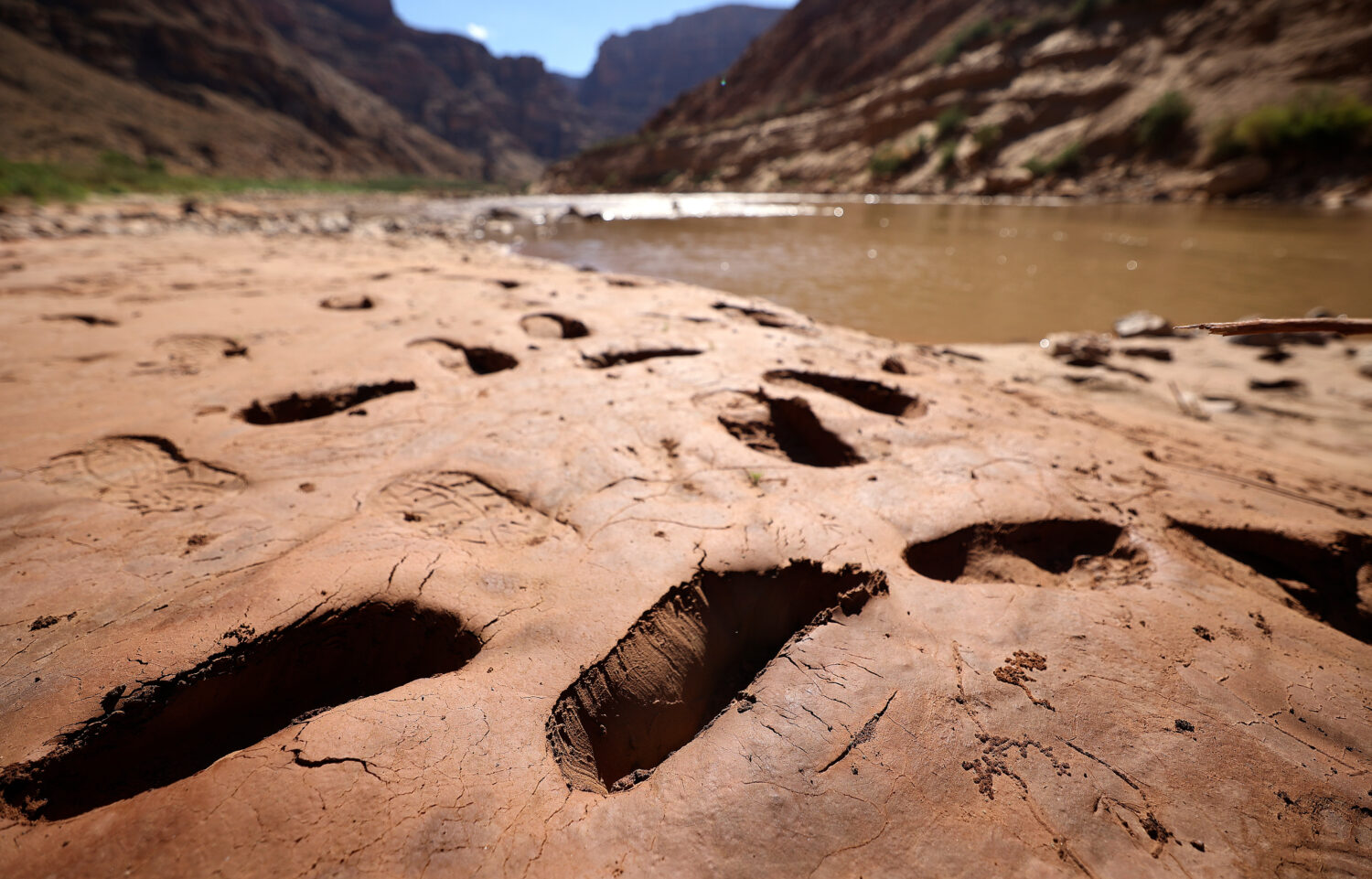 Footprints where people have sunk into mud are pictured above Gypsum Canyon rapid in Cataract Canyon on the banks of the Colorado River on Friday, Sept. 20, 2024. (Photo credit: Kristin Murphy, Deseret News)