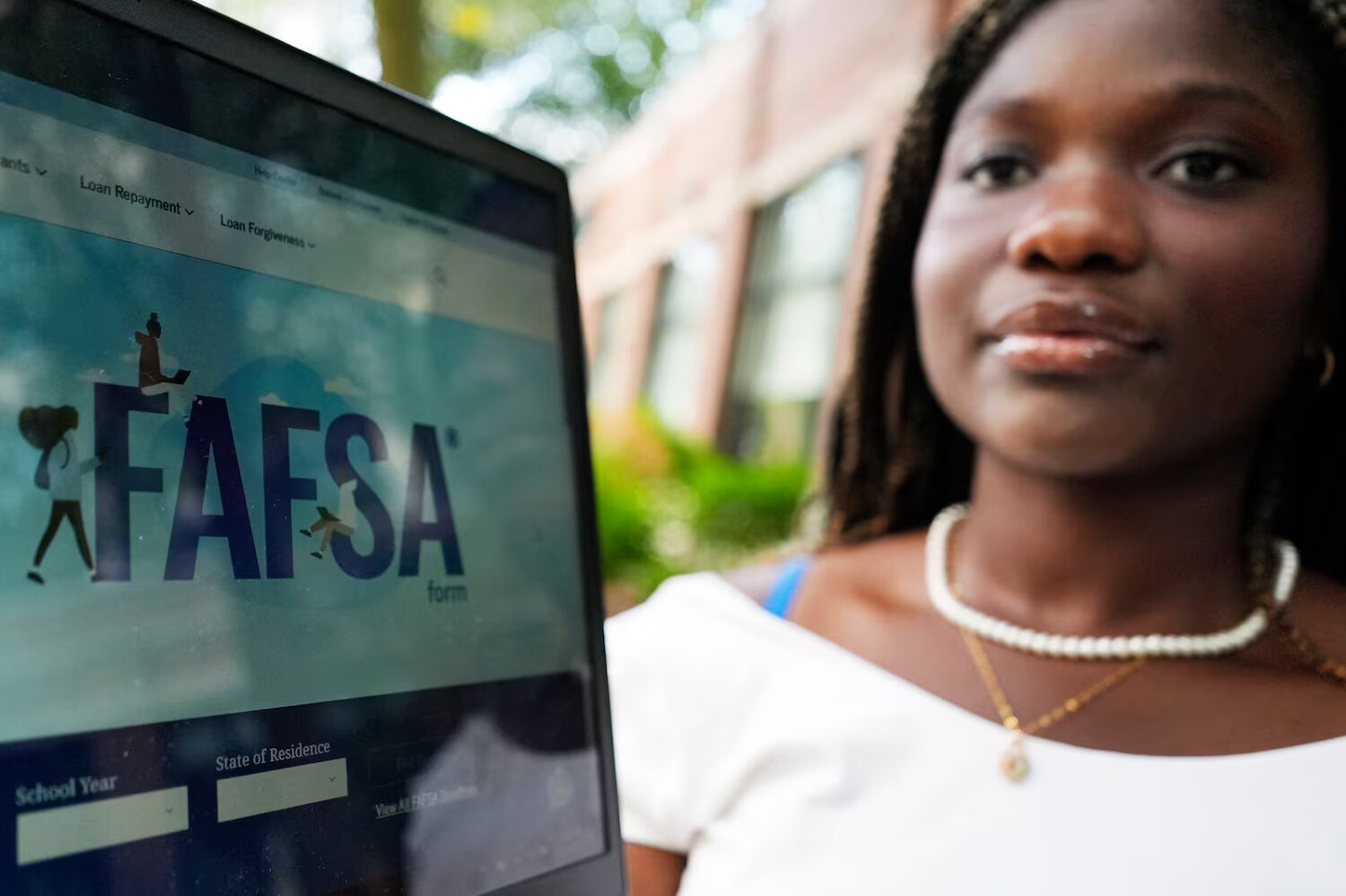 FAFSA website is seen on the laptop as Adjovi Golo holds a laptop at DePaul University in Chicago, Wednesday, Aug. 28, 2024.