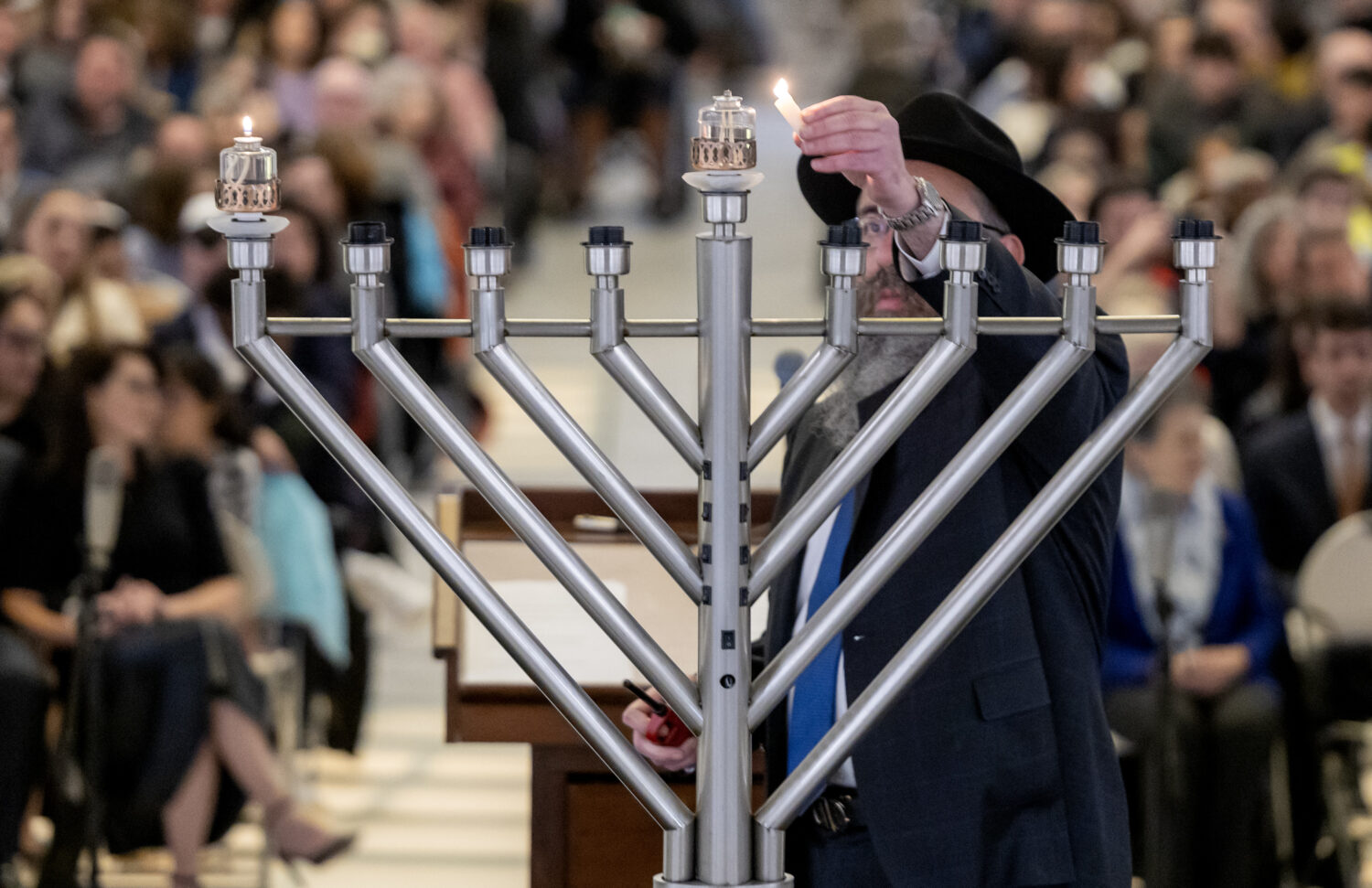 Rabbi Benny Zippel lights the center candle as members of Utah’s Jewish community gather at the Capitol in Salt Lake City to welcome in the holiday of Chanukah, or Hanukkah, by lighting a menorah on Sunday, Dec. 18, 2022. (Scott G Winterton, Deseret News)