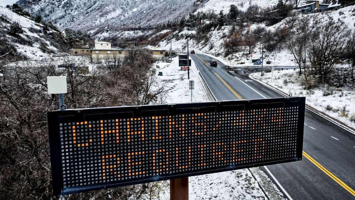 A sign for the canyon traction law is displayed at the mouth of Big Cottonwood Canyon in Cottonwood...