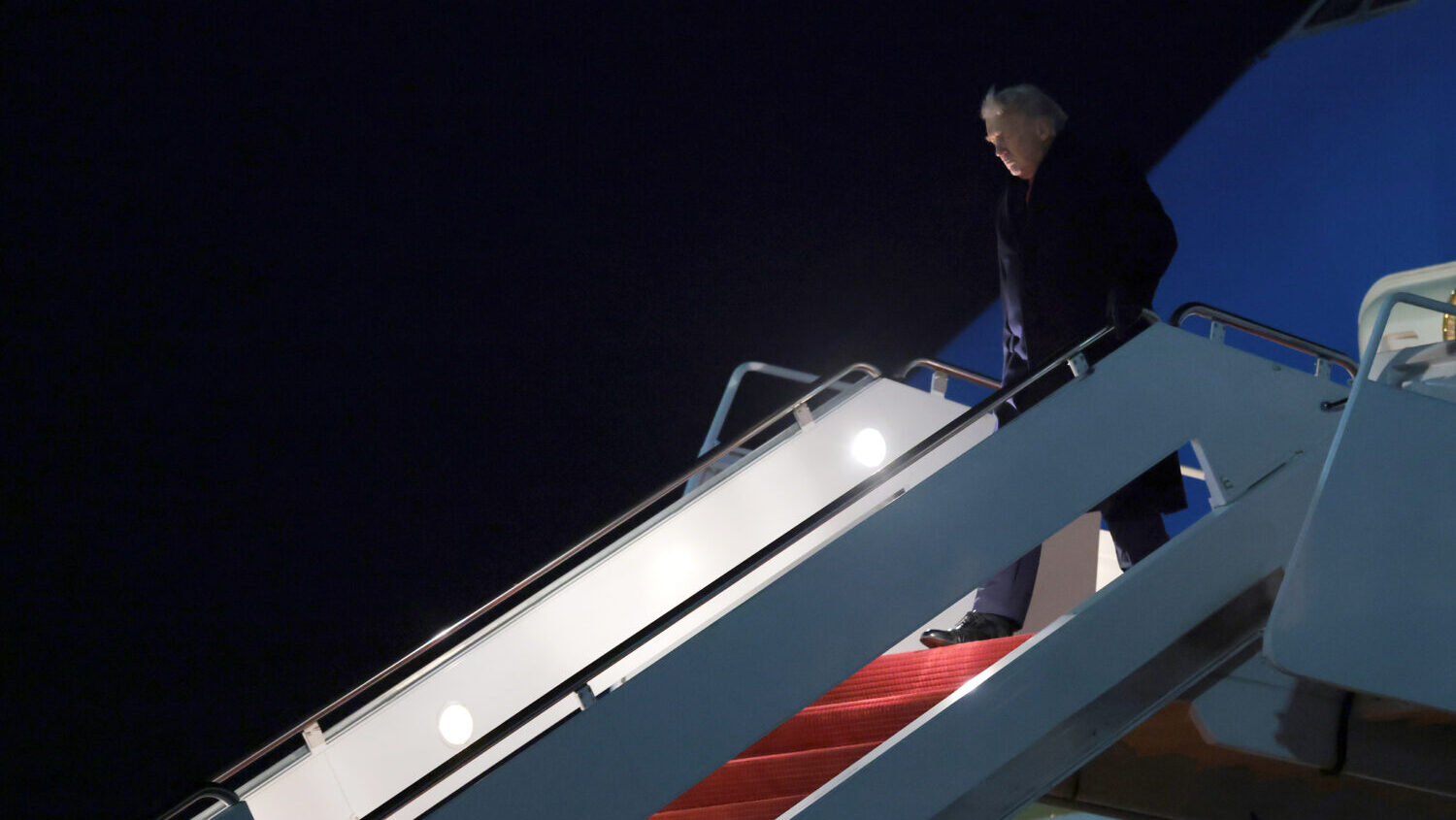 U.S. President Donald Trump walks off Air Force One on January 19, 2026 in in Joint Base Andrews, M...