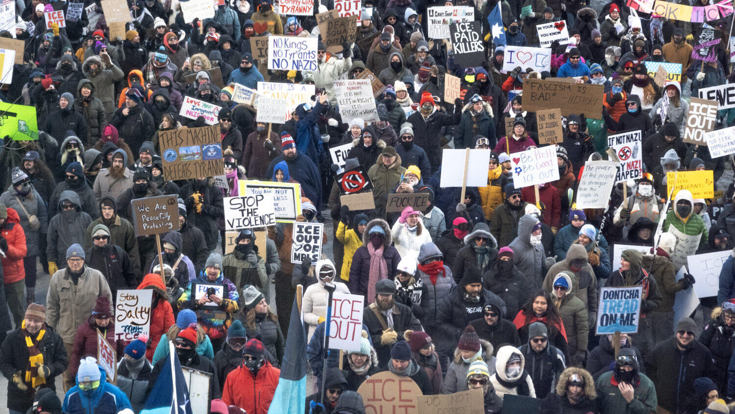 Demonstrators march through downtown protesting ICE operations and the death of Renee Good and Alex...