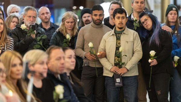 People show their support during a vigil held for Alex Pretti at the Capitol in Salt Lake City on T...