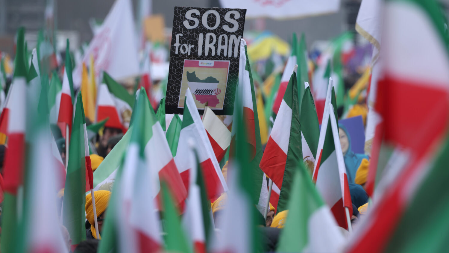 People holding pre-1979 Iranian flags gather to protest for the overthrow of the current Iranian re...