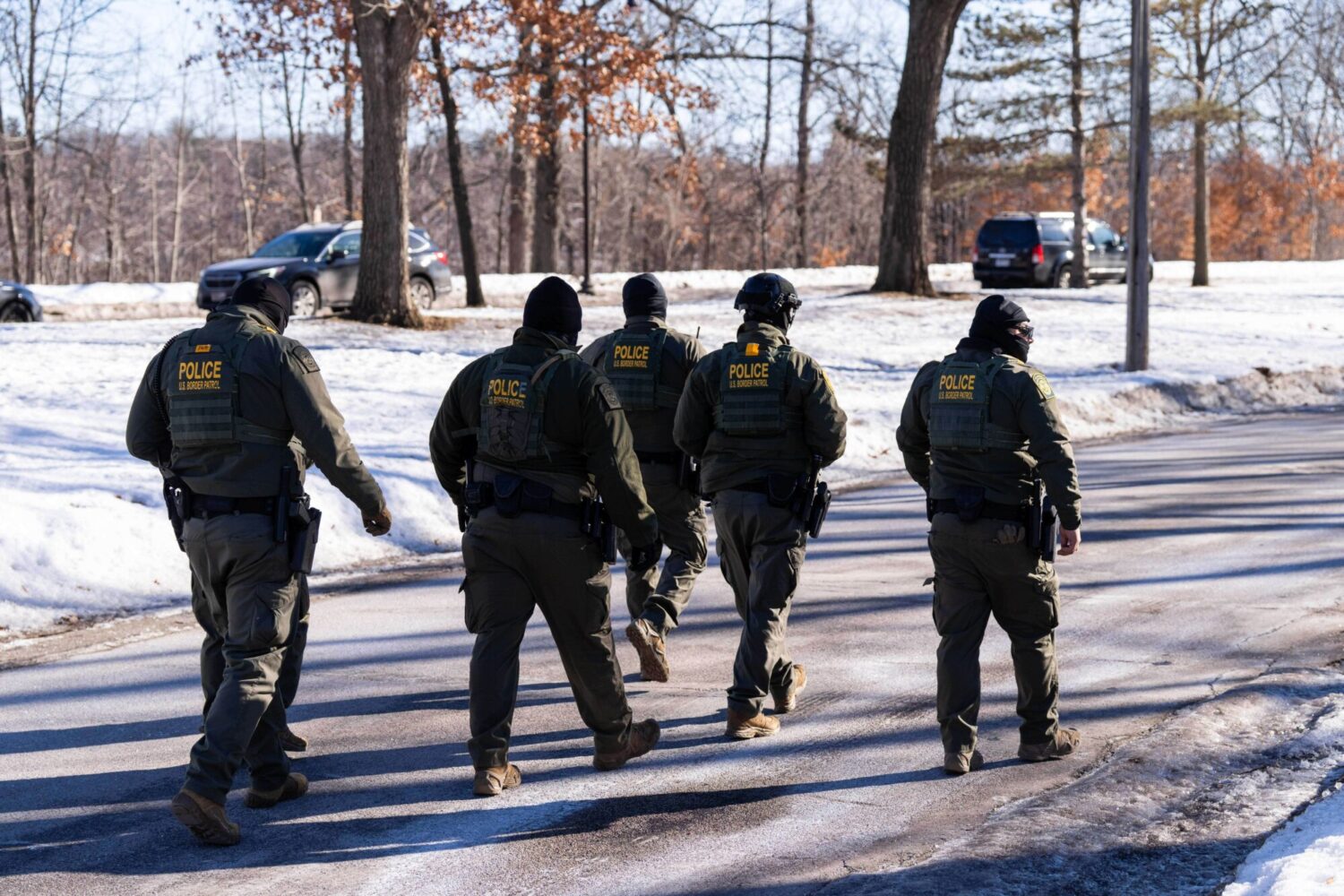 FILE - U.S. Border Patrol officers walk along a street in Minneapolis, Wednesday, Jan. 14, 2026....