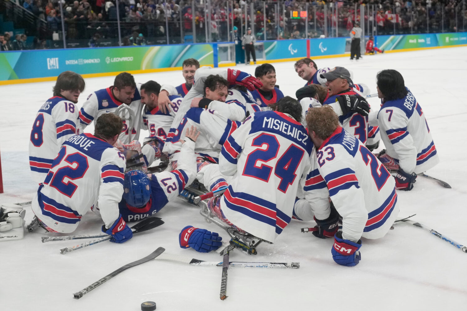 US players celebrate after winning the gold medal at the end of the ice hockey match between United...