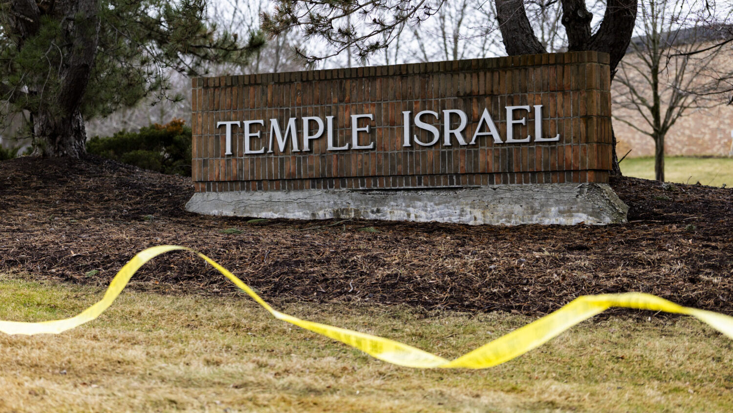 Caution tape near the front entrance of Temple Israel a day after an active shooter incident on Mar...