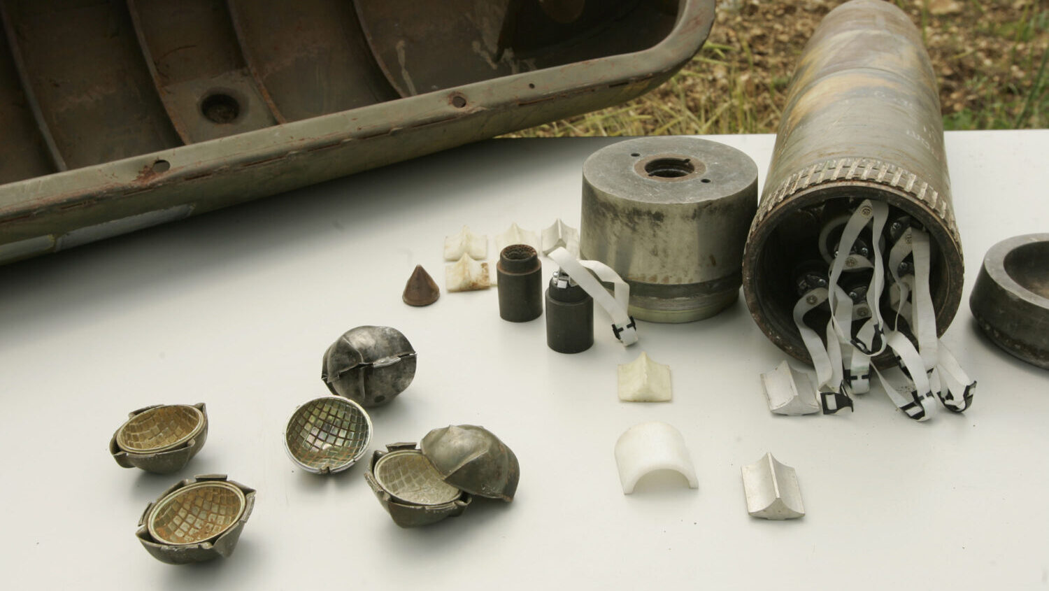 Parts of a cluster bomb are displayed near the Belgian Camp on April 20, 2007 in Tibnin, Lebanon....