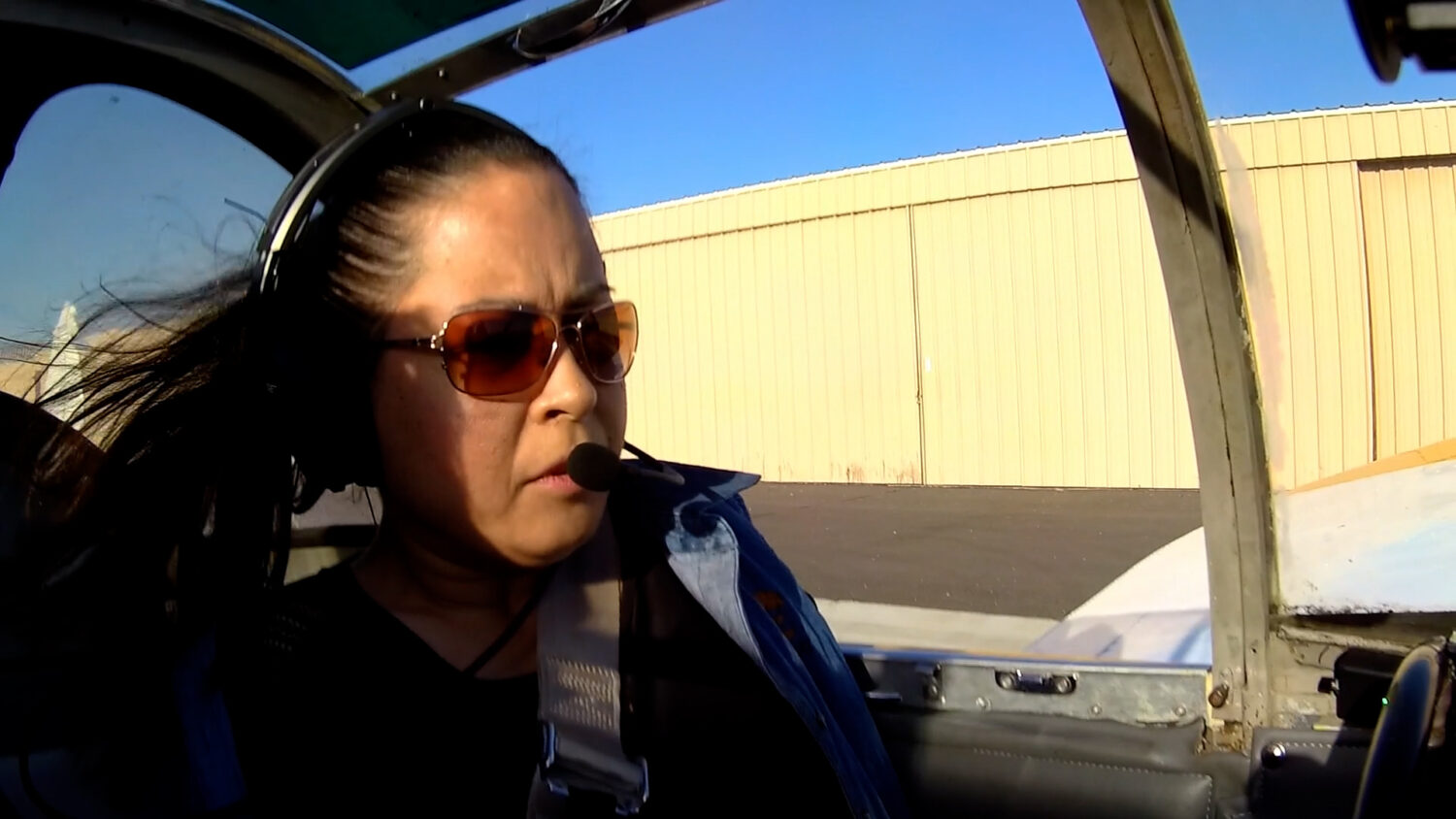 Jessica Cox, a pilot and motivational speaker, inside the cockpit of a small airplane. (Courtesy Jessica Cox and Utah State University)
