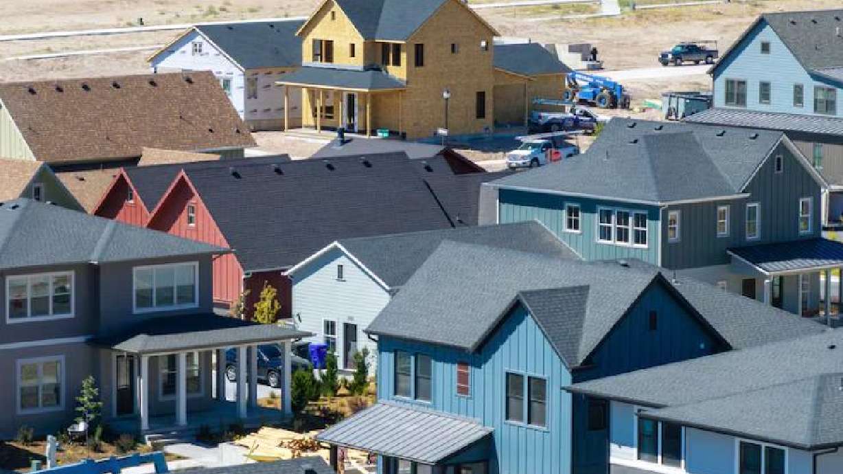 Workers build homes in West Jordan in this August 2025 photo.