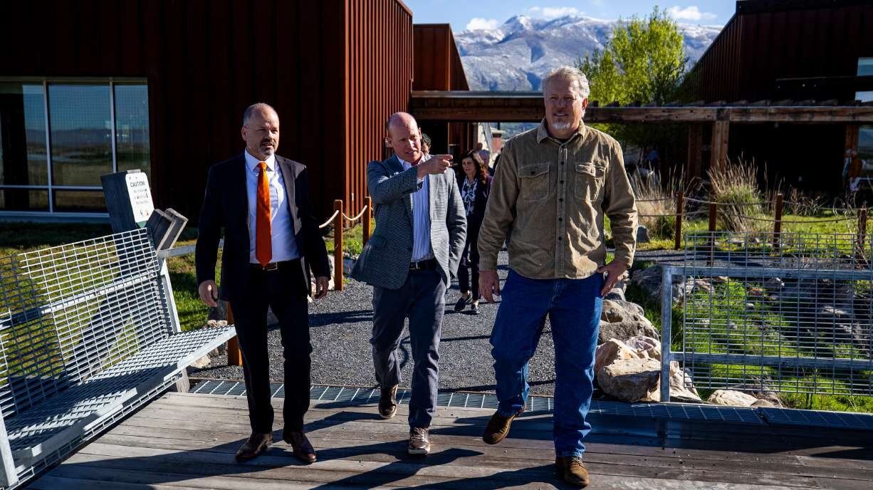 Joel Ferry points toward the Great Salt Lake as he walks with Timothy Hawkes and Greg Miller to the...