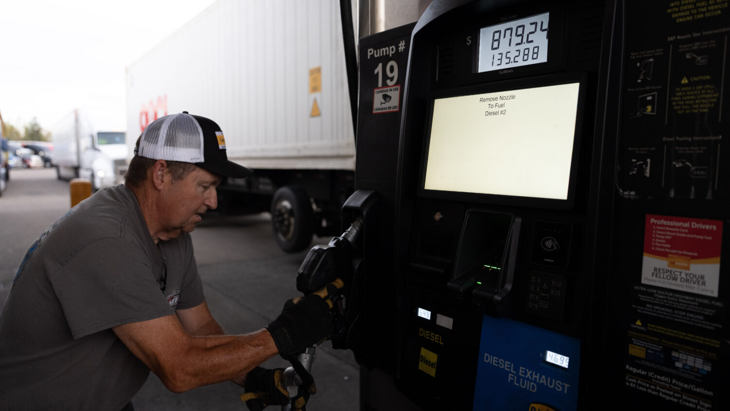 Chuck Byrd puts away a fuel nozzel after filling two tanks for a truck at a gas station on Tuesday,...